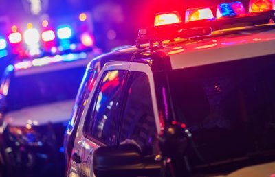 Night Time Police Intervention Night Time Police Violent Crime Intervention. Police Vehicles with Flashing Lights.